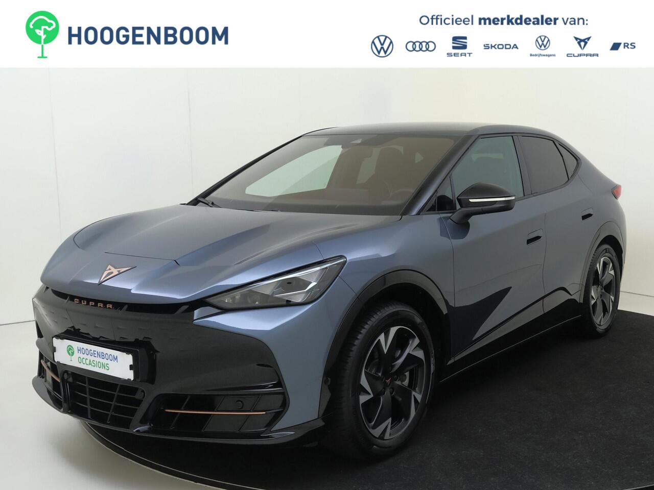 Cupra Tavascan Business 82 kWh | SoH 100% | Trekhaak | Achteruitrijcamera | 3-zone airco | Dodehoek detectie | Keyless | Adaptieve cruise control | CarPlay | Stoel- en stuurwielverwarming |