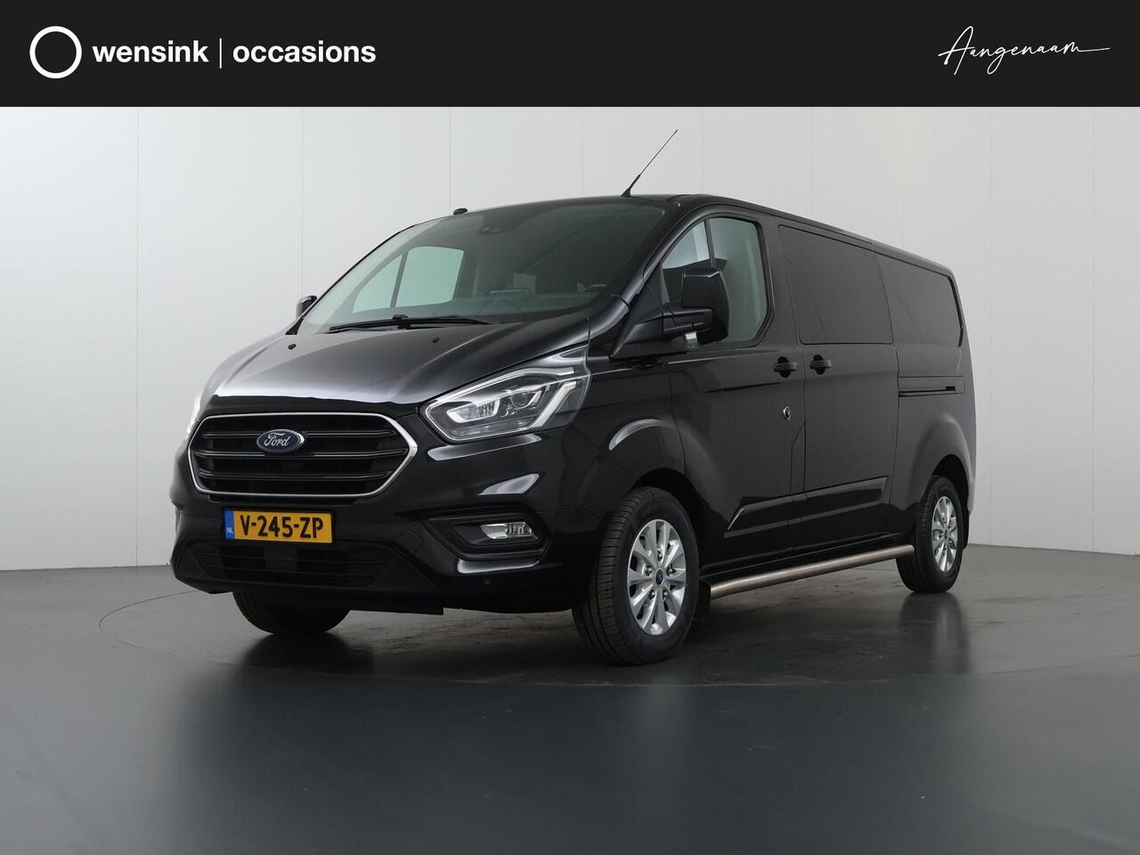 Ford TRANSIT CUSTOM 300 2.0 TDCI | L2 H1 | LIMITED | DUBBEL CABINE | AUT. | LEDEREN BEKLEDING | CAMERA | ADAPTIEVE CRUISE | STOELVERWARMING | NAVIGATIE | BI-XENON | 2X ZIJSCHUIFDEUR | AGATE BLACK METALLIC