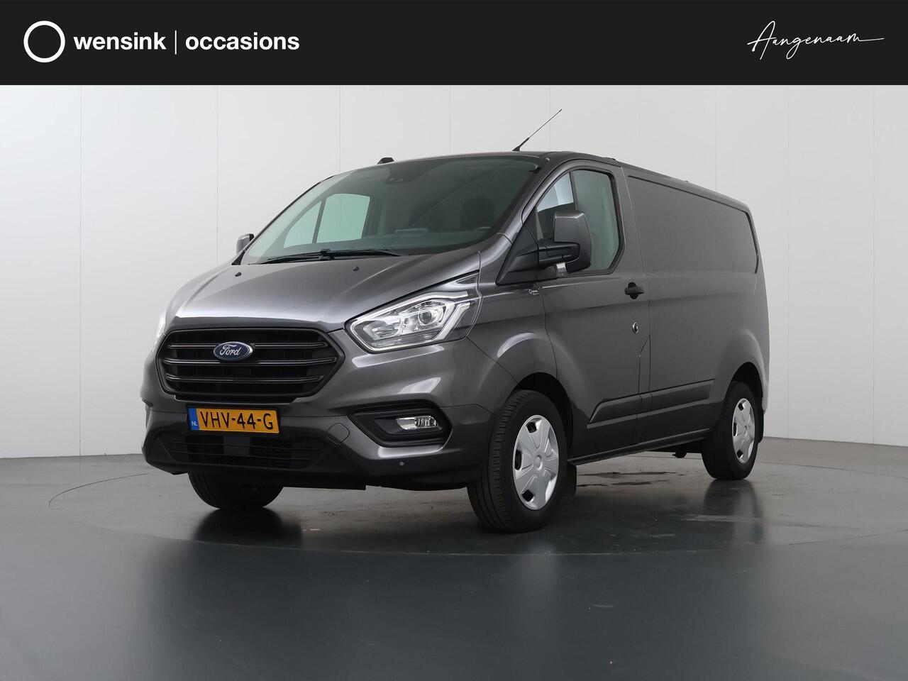 Ford TRANSIT CUSTOM 340 2.0 TDCI | L1 H1 | TREND | ACHTERUITRIJCAMERA | PARKEERSENSOREN | 3-ZITS | METALLIC | TREKHAAK | BETIMMERDE LAADRUIMTE | VOORRUITVERWARMING | CRUISE CONTROL | DAK DRAGERS
