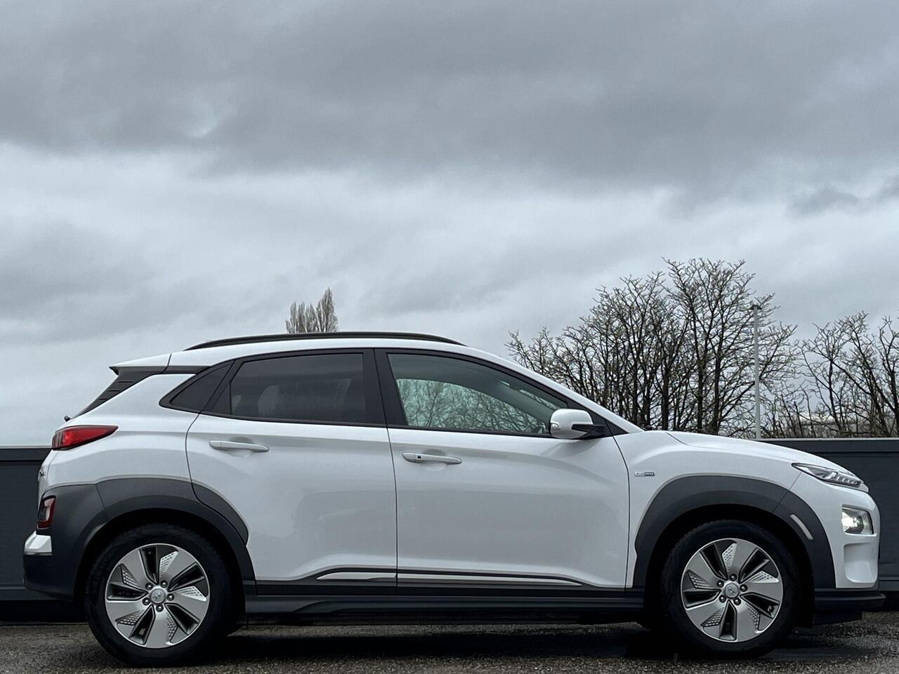 Hyundai Kona EV Premium 64 kWh | SOH 100% | 3-Fase OBC | Schuifkanteldak | Lederen bekleding | Long Range Accu | Volledig dealer onderhouden | Allseason banden | Trekhaak ,afneembaar |