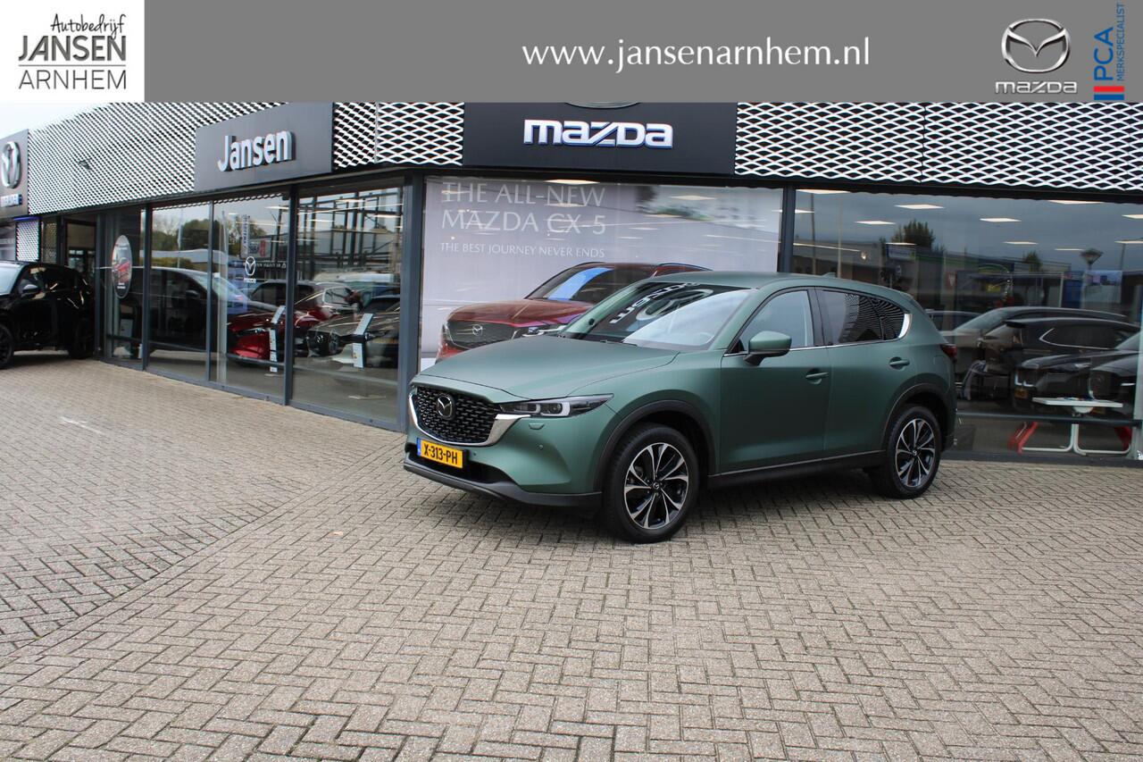 Mazda CX-5 2.0 e-SkyActiv-G M Hybrid 165 Exclusive-Line+Com.P , Automaat, Matte Metallic Pine Green gewrapped, Black Comfort Pack, Navi, Adap.Cruise, Clima, Apple Carplay, 360 Camera, PDC, HUD, Stuur/Stoelverwarming, 19" LMV