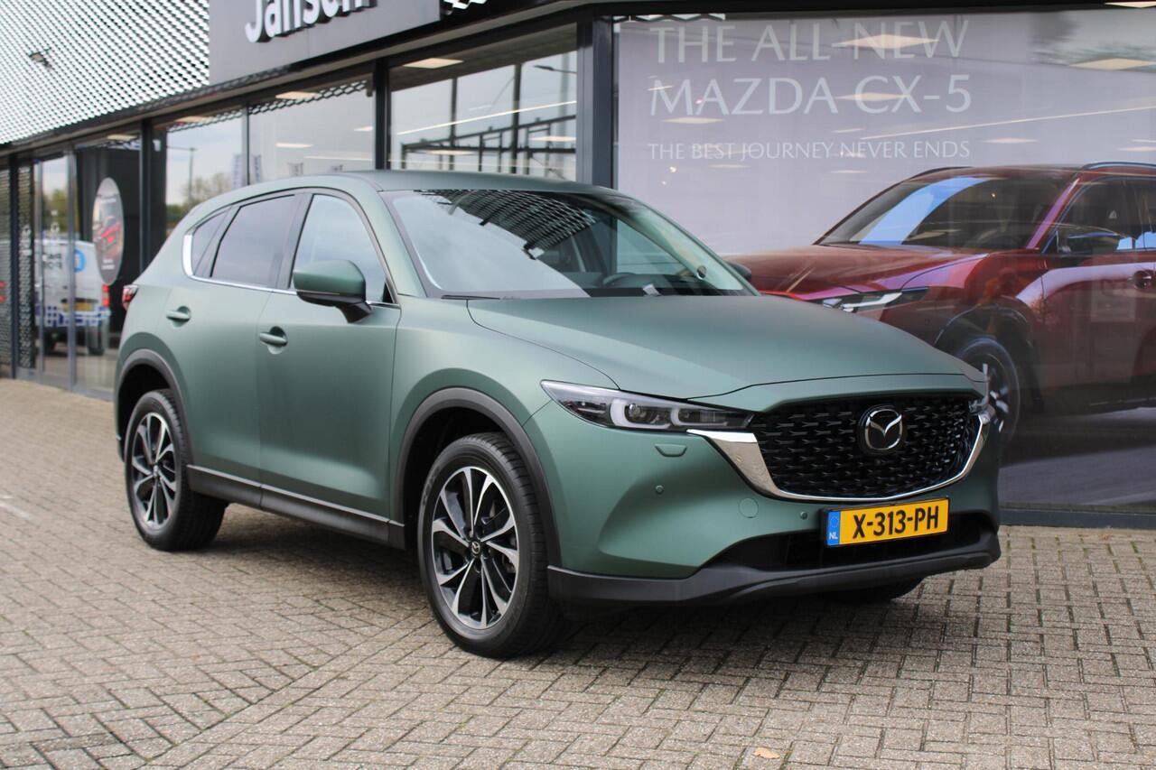Mazda CX-5 2.0 e-SkyActiv-G M Hybrid 165 Exclusive-Line+Com.P , Automaat, Matte Metallic Pine Green gewrapped, Black Comfort Pack, Navi, Adap.Cruise, Clima, Apple Carplay, 360 Camera, PDC, HUD, Stuur/Stoelverwarming, 19" LMV