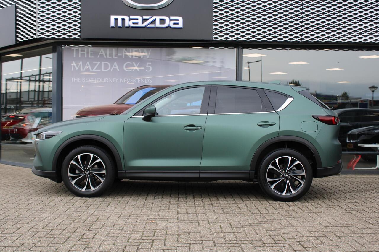 Mazda CX-5 2.0 e-SkyActiv-G M Hybrid 165 Exclusive-Line+Com.P , Automaat, Matte Metallic Pine Green gewrapped, Black Comfort Pack, Navi, Adap.Cruise, Clima, Apple Carplay, 360 Camera, PDC, HUD, Stuur/Stoelverwarming, 19" LMV