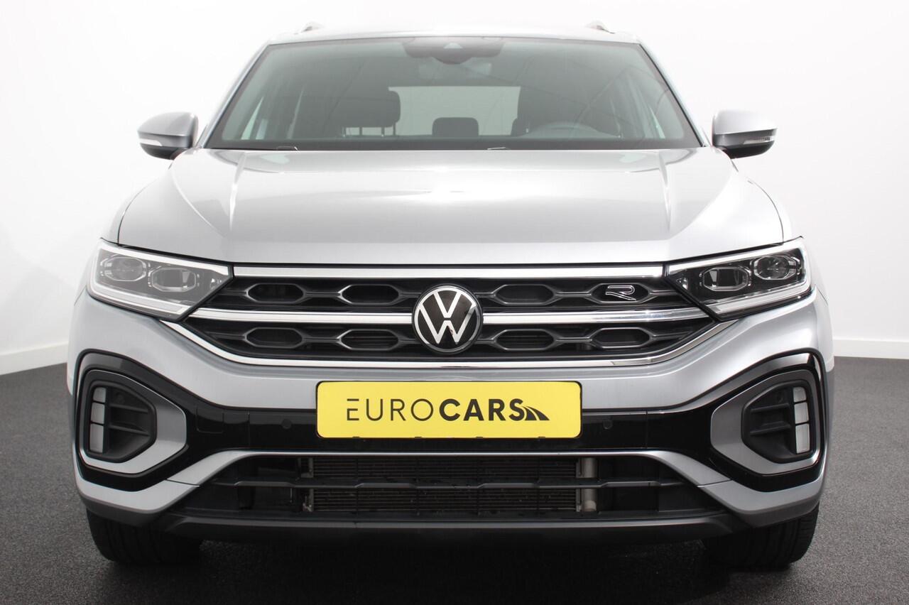 Volkswagen T-Roc 1.5 TSI 150pk DSG R-Line | Navigatie | Apple Carplay/Android Auto | Parkeersensoren | Camera | Blind Spot Assist | Adaptive Cruise Control | Elektrische achterklep | Stoel- en stuurverwarming | Climate Control | Ledverlichting | Virtual Cockpit